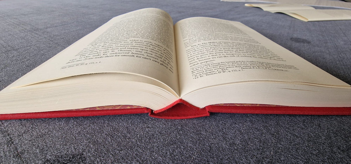The Spiritual Life lying open flat, red cloth binding
