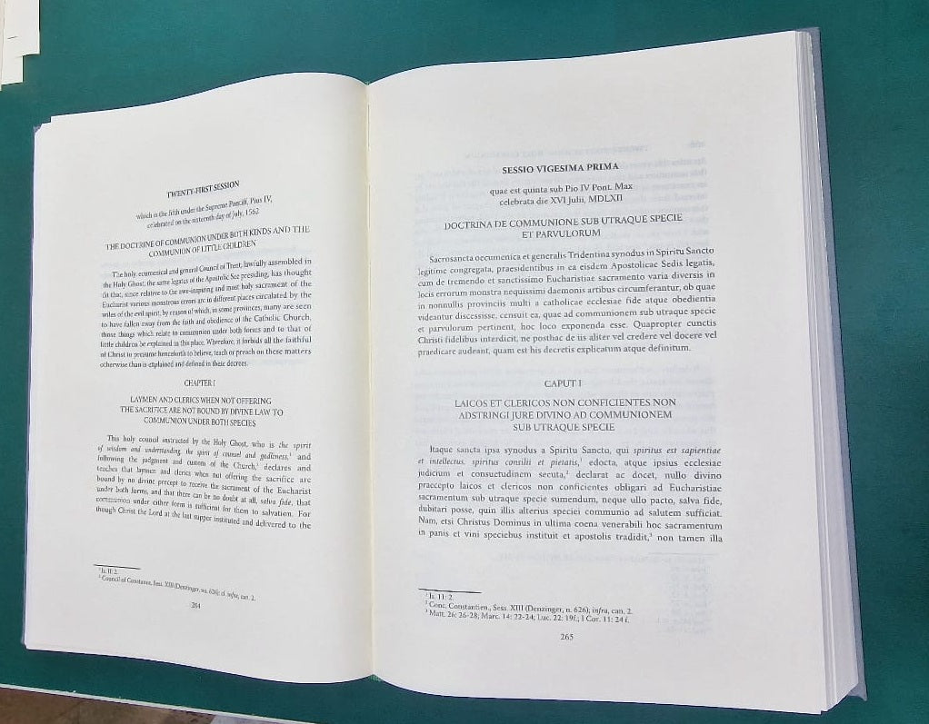 Canons and Decrees of the Council of Trent open, showing Latin and English on facing pages