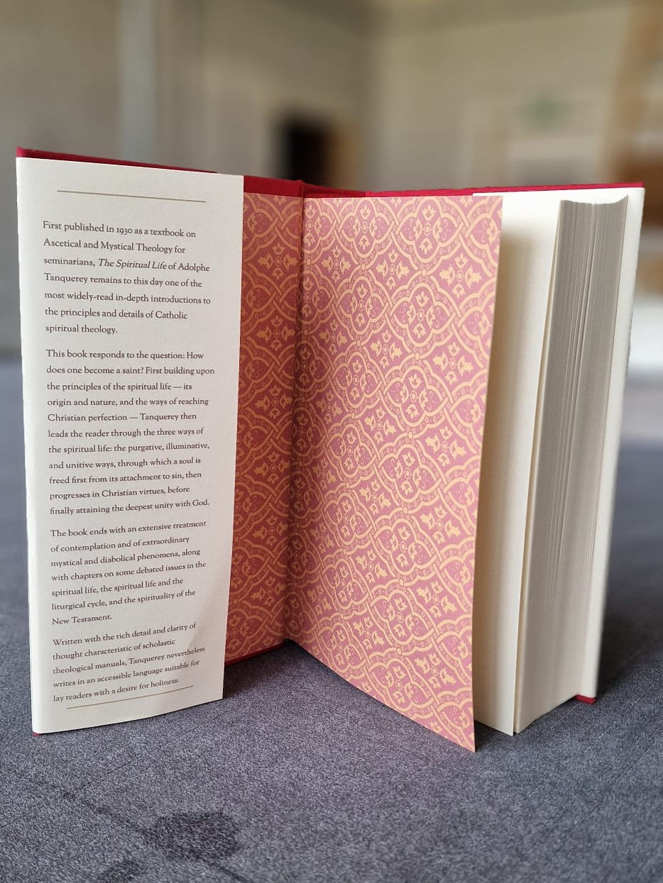 The Spiritual Life standing open to show its red patterned endpapers